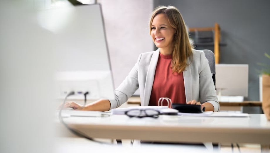 woman smiling at a desk