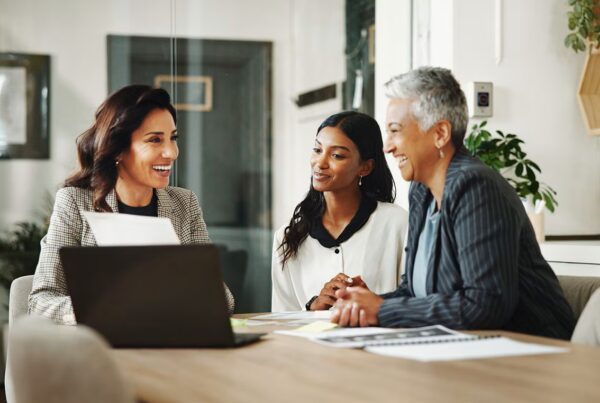 three people sitting at a table