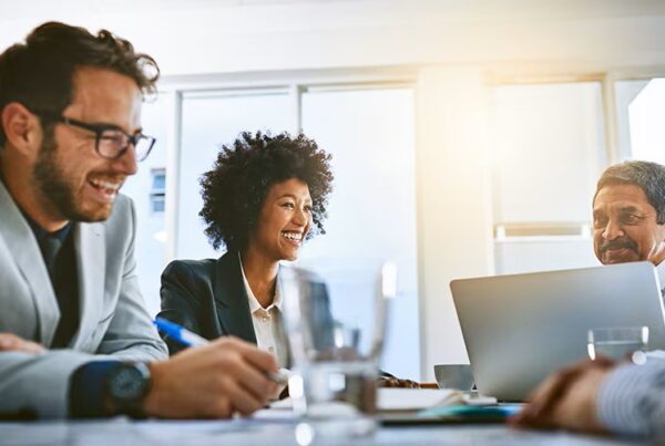 people laughing at an office table