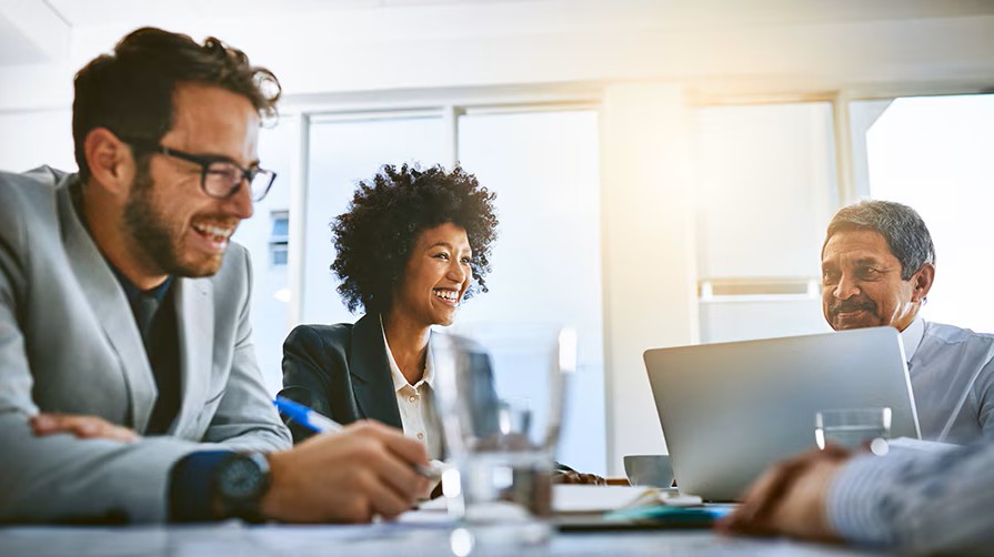 people laughing at an office table