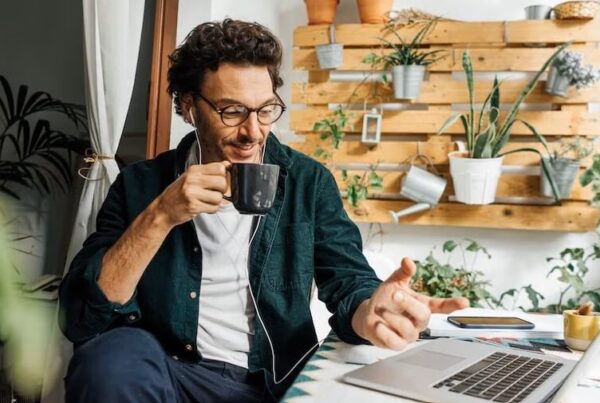 man with coffee sitting a desk