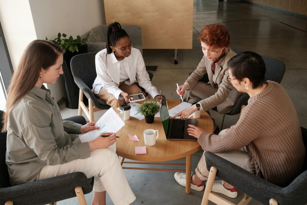 four people siting around a table