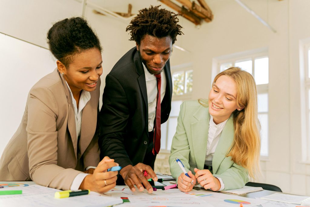 three people looking over a document