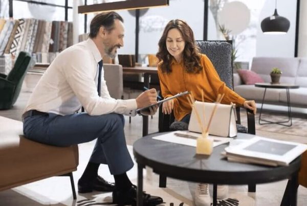 man sitting smiling at coffee table
