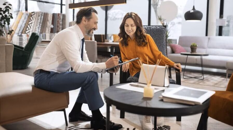man sitting smiling at coffee table